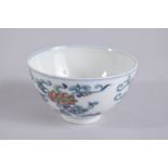 A CHINESE DOUCAI PORCELAIN BOWL, painted with floral motifs, base with six-character mark, 9cm