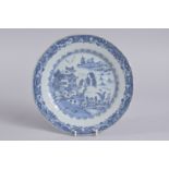 A 19TH CENTURY CHINESE BLUE AND WHITE PORCELAIN DISH, painted with a landscape scene, (faults), 23cm