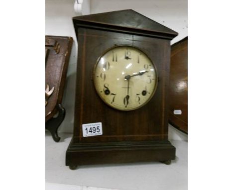 A mahogany inlaid mantel clock the dial marked Gilbert