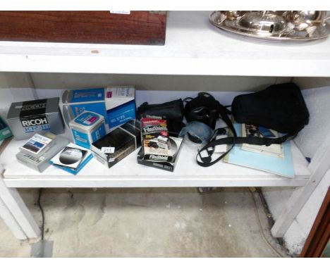 A Ricoh SLR camera, lenses, cases, filters etc
