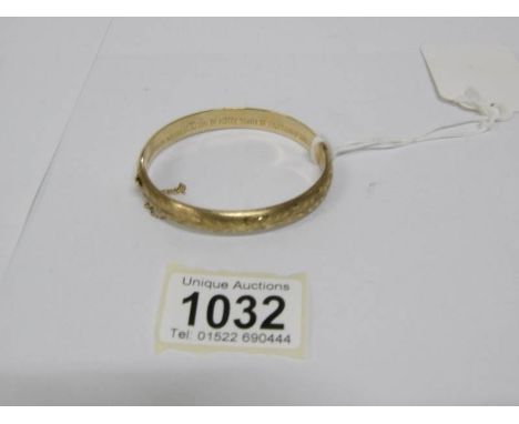 A 9ct gold engraved bangle, 9gms