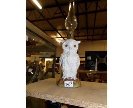 A large Continental porcelain owl oil lamp