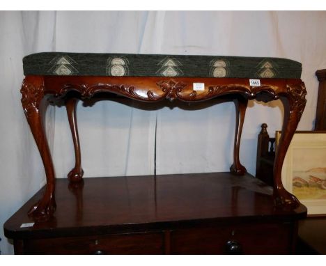 A reproduction mahogany duet stool