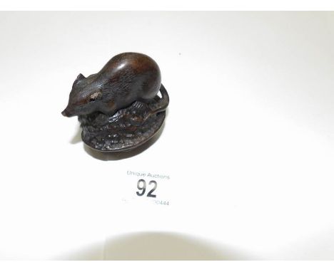 A bronze mouse on a nut