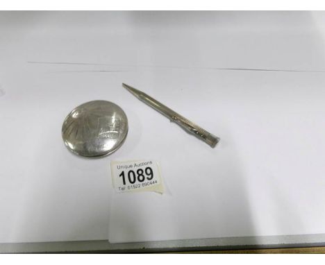 A silver compact and a silver propelling pencil