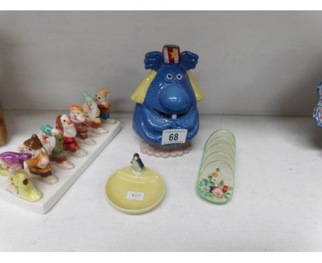 A wade novelty money box, a Wade penguin pin tray, a seven dwarfs toast rack and a Crown Devon toast rack
