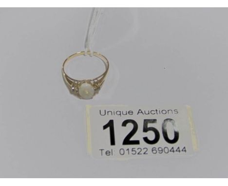 An 18ct gold ring set centre opal and with diamond set shoulders