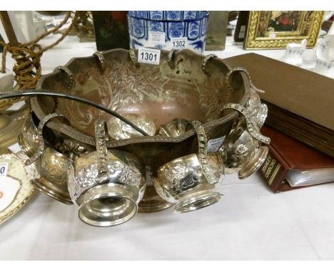 A silver plate punch bowl, cups and ladle (one cup a/f)