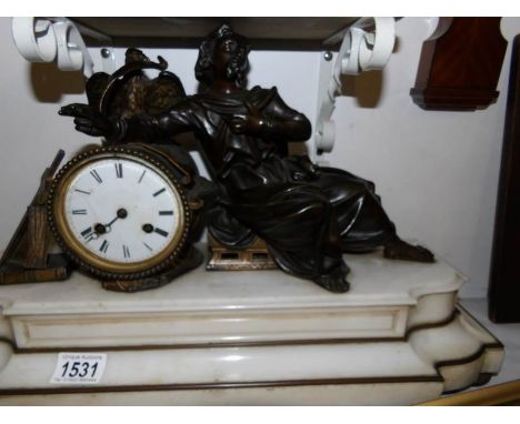A French mantel clock surmounted bronze figure