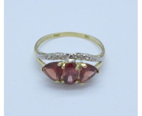 A 9ct gold, garnet and diamond ring, 1.4g, O