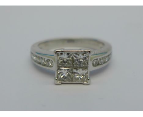 An 18ct white gold and diamond cluster ring, 1 carat diamond weight, set with four square cut diamonds and ten brilliant cut 