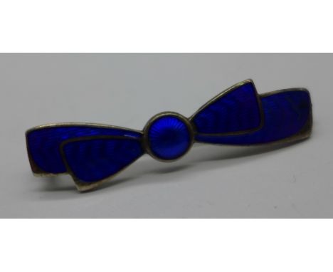 A silver and enamel bow tie brooch, CH monogram to back, enamel a/f, 48mm