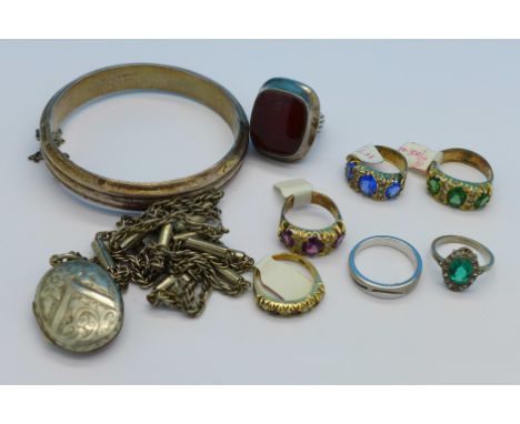 A silver bangle, a locket and chain and seven rings