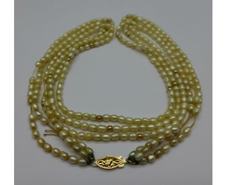 A freshwater pearl necklace with hallmarked 14ct gold clasp