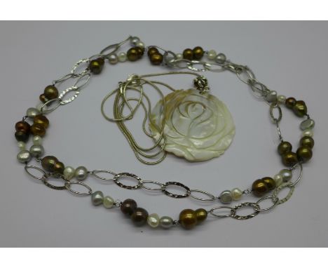 A silver and pearl necklace and a silver mounted mother of pearl pendant and chain