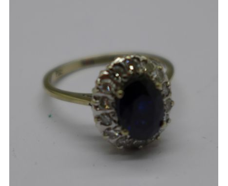 An 18ct white gold, sapphire and diamond cluster ring, 3.2g, N