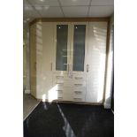 A Fitted Bedroom Display comprising: 2 Single Door Wardrobes; 4 drawer Chest; Glazed Double Door