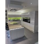 A Fitted Kitchen Display comprising: Tall Larder Cupboard; 7 Small Cupboards; Undersink Cupboard;