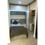A Fitted Bedroom Display comprising: Overbed Bridge Unit; Wardrobe; 2 drawer Bedside Cabinet; Desk