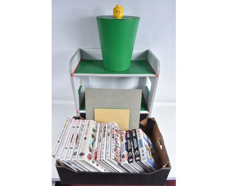 A COLLECTION OF LEGO STORAGE ACCESSORIES AND BOOKS, to include a a lego storage tub with Minifigure head handle lid, numbered