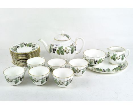 A six person Royal Worcester tea set decorated with branches of flowering and fruiting blackberries on a white ground