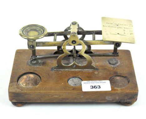 A set of Victorian Mordon &amp; Co. postal scales, with brass quatrefoil stand issuing scales stamped with rates of postage, 