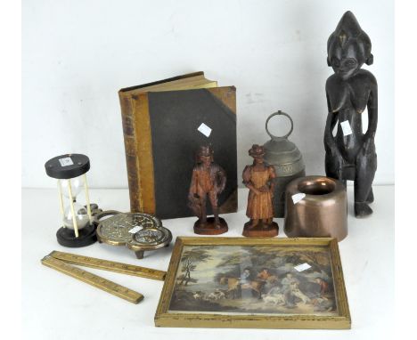 A carved wooden African figure, together with a metal bell, foldable ruler, a copy of 'The Popular Educator, a Complete Encyc