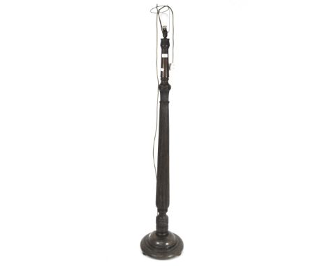 An early 20th century wooden standard lamp with turned and fluted support on round base, height to fitting 150cm