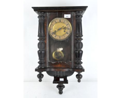 An early 20th century mahogany cased Vienna Wall clock, the dial with Roman numerals denoting hours, with pierced and turned 