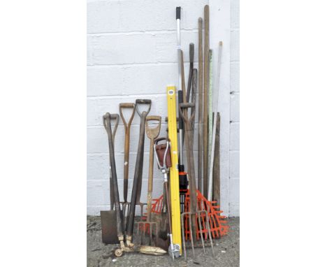 A collection of gardening tools, including spades, pitchforks and shears, together with a shooting stick