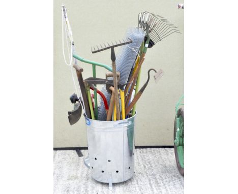 A large collection of gardening and work tools, including saws, spades, shears and more