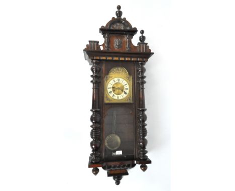An early/mid 20th century Vienna wall clock , mahogany cased, the enamel ring dial with Roman numerals denoting hours, carved