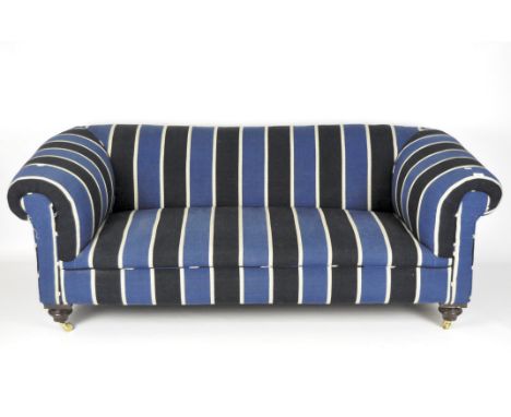 An upholstered blue and white chesterfield style sofa, raised upon castors, measuring approximately 68cm x 175cm x 85cm