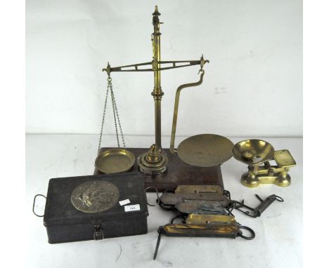A group of scales and weights, including balance scales, pocket balance and more, including a selection of weights