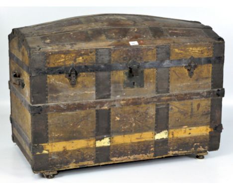 A late 19th/early 20th century dome topped wooden travelling trunk, 93cm wide