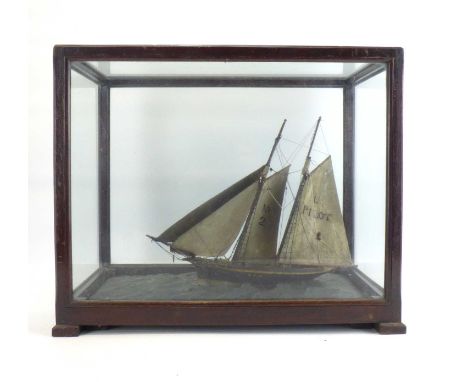 A late 19th/early 20th century wooden model of a two-masted sailboat with 'No.2' to one sail, the other inscribed with letter
