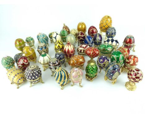 Approximately forty-four miniature Fabergé-style egg trinket boxes, mostly on stands, various designs and sizes, height of la