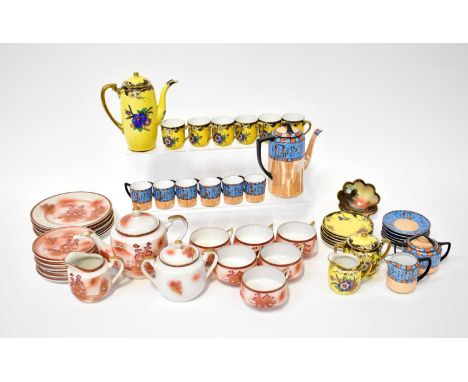 A Japanese geisha eggshell tea set printed and painted with a mountainous landscape, with gilt highlighting on a pink ground,