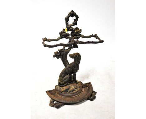 A 19th century Coalbrookdale-style cast iron double stick stand with naturalistic column, dog figure to the front and half cr