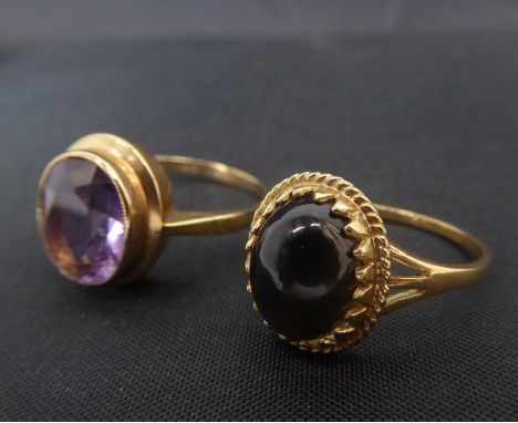 Two 9ct gold dress rings comprising a smoky quartz cabochon in 9ct gold oval mount, split shoulders, size N and an oval cut a