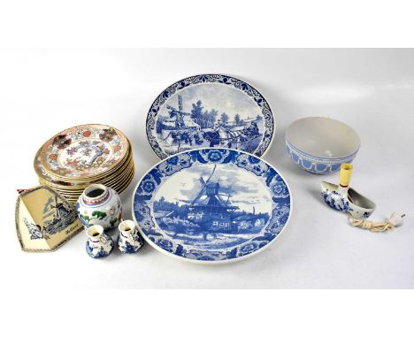 A pair of Dutch Delft blue and white wall plaques with scenes of 19th century Holland, a Dutch Delft clog table lamp, two Del