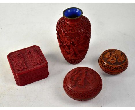 A group of four 20th century cinnabar items, a red baluster vase with electric blue enamel interior, a circular pot with cove