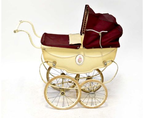 A vintage mid-20th century Silver Cross dolls' pram, cream body with maroon hood and apron.Condition Report; body of pram and