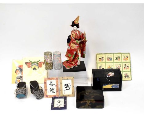 A good quantity of modern Oriental items to include geisha shoes, various tins, prints, a full model of a geisha in tradition