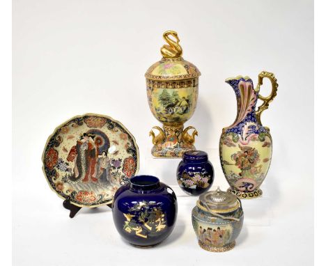 A group of six Oriental and Oriental inspired ceramics comprising a large decorative wall plaque with figural decoration and 