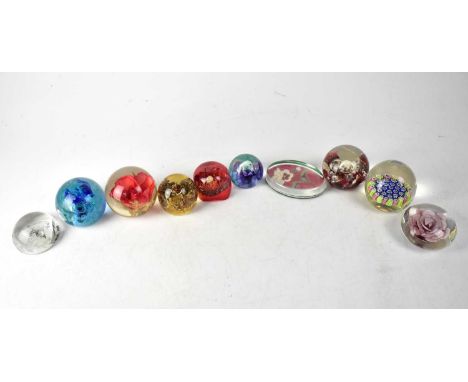 A collection of ten paperweight s to include a Murano Millefiori example, and Edinburgh Armorial paperweight, a Caithness exa
