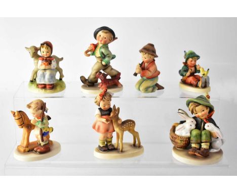 HUMMEL; seven figures of children, to include a boy with umbrella and dog, a little girl with deer, a boy with rabbit, etc.Qt