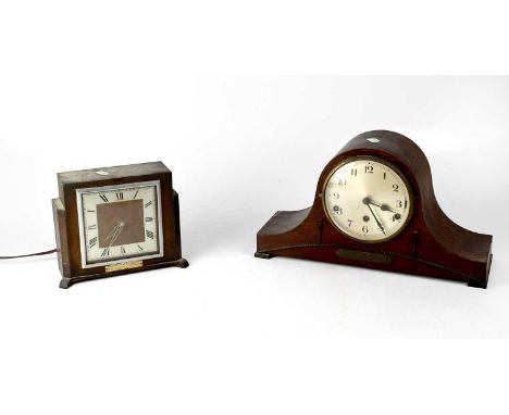 An early 20th century Napoleon hat mantel clock, the silvered dial set with Arabic numerals, above a presentation plaque insc