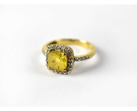 A 9ct yellow gold dress ring with square central yellow stone, probably citrine, in a square border of tiny diamonds, with ti