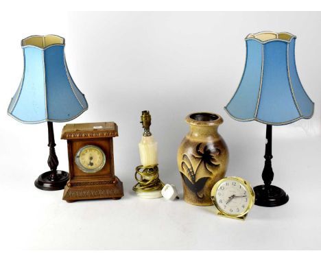 A pair of mahogany column table lamps to stepped circular base, with blue silk-effect fabric shades, an onyx table lamp, a mi